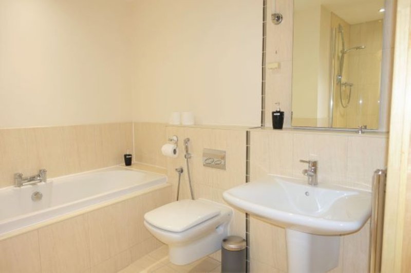 Bathroom with bathtub, toilet, pedestal sink and shower enclosure