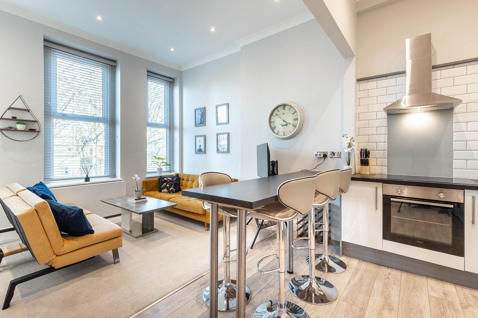 Enjoy a bright, stylish open-plan living space that seamlessly combines the lounge, dining area, and fully equipped kitchen. Large windows fill the apartment with natural light, creating a welcoming h