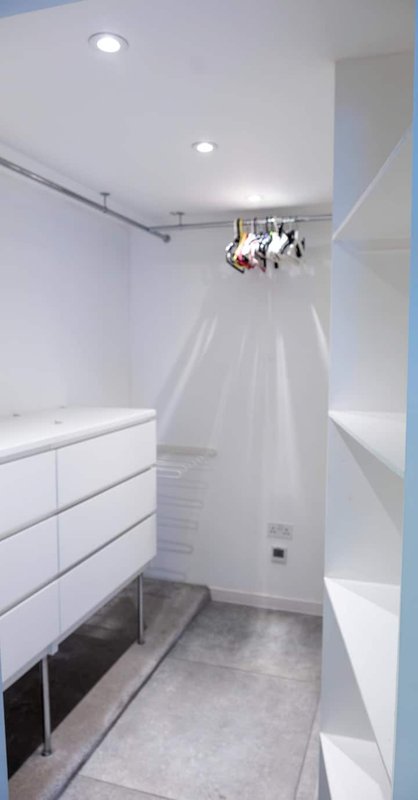 Modern bathroom with white cabinetry, shower enclosure, recessed lighting and grey tile flooring