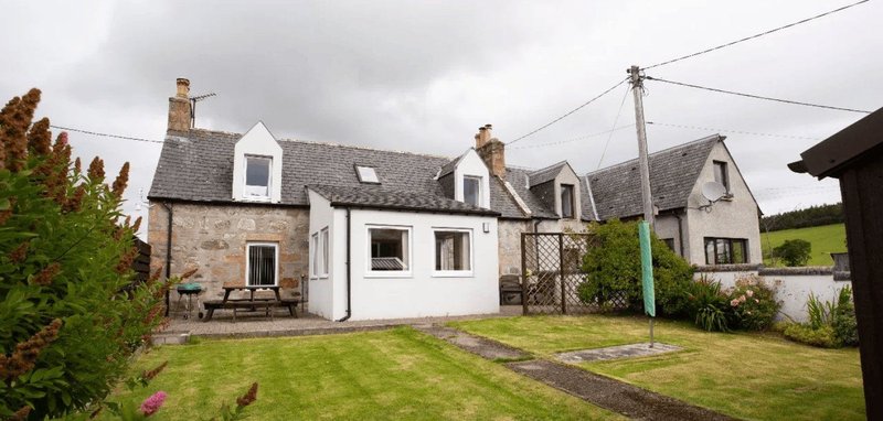 Stone and white-painted cottage with garden, driveway and surrounding grounds