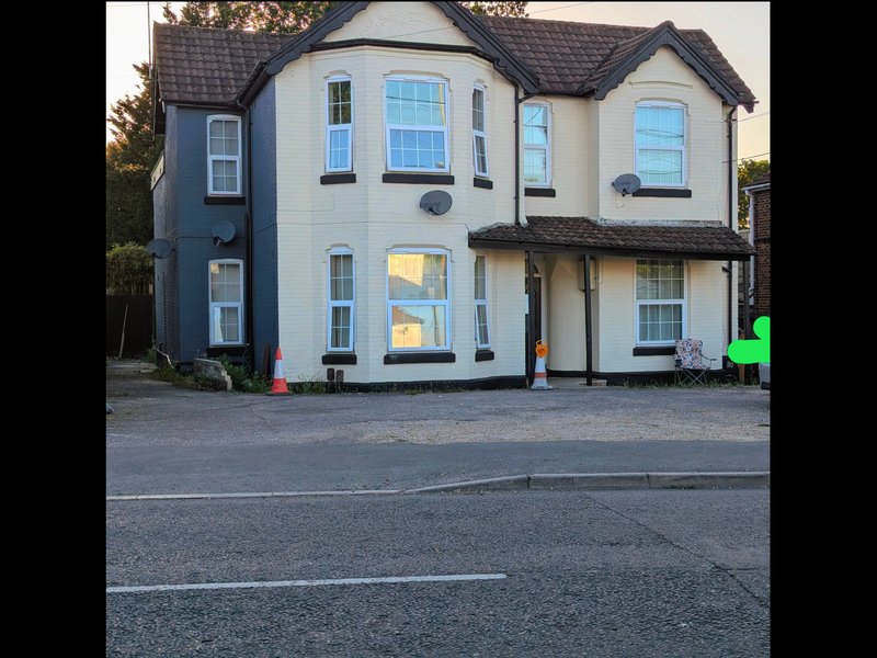 Two-storey detached house with cream and grey exterior, driveway and street frontage