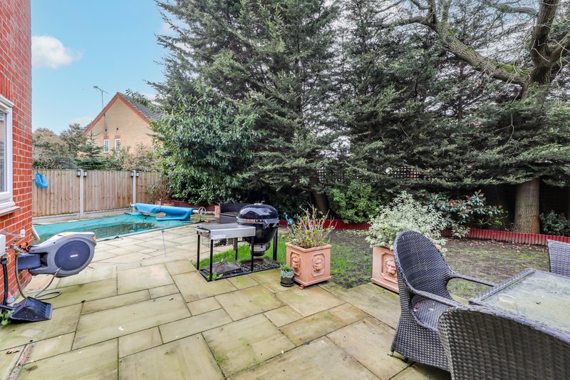 Garden patio with swimming pool, outdoor furniture, grill and mature trees
