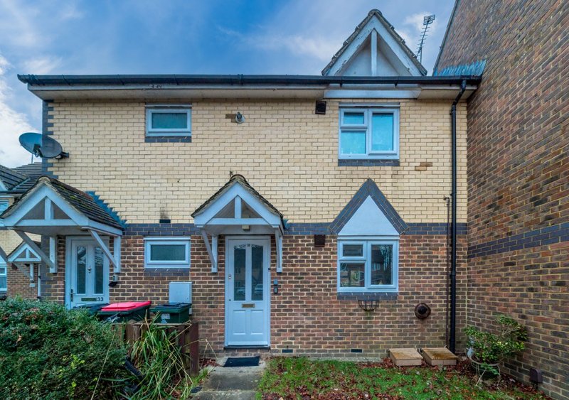 Brick and stone semi-detached house exterior with blue doors and windows