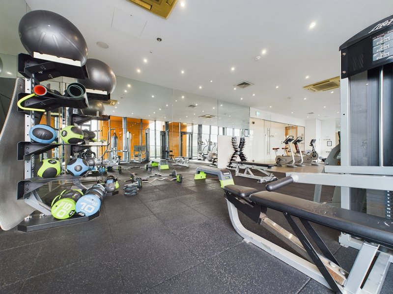 Modern gym interior with exercise equipment, weights, treadmills and mirrors