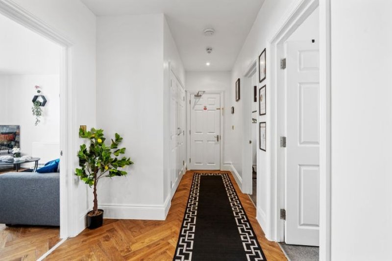 Bright entrance hallway providing access to the apartment's bedrooms and living areas.