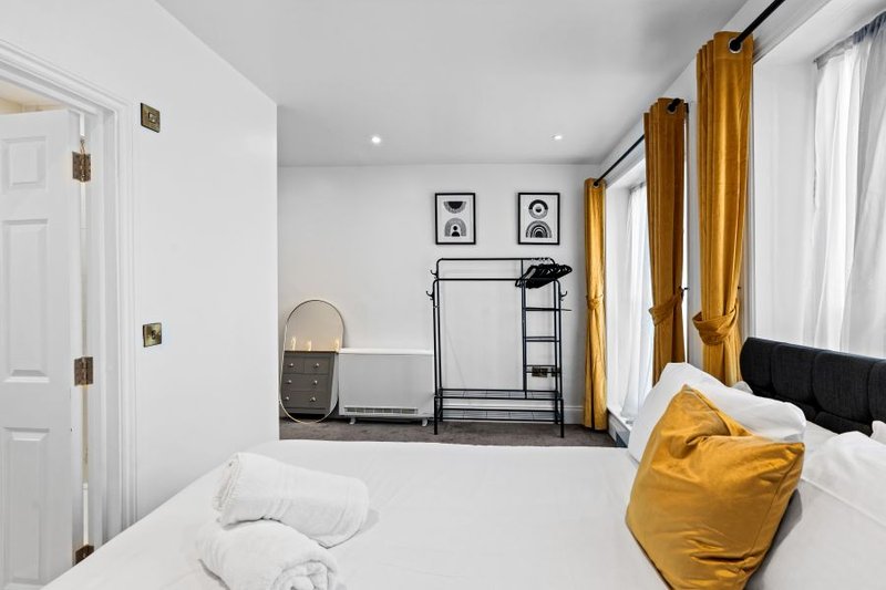 Spacious bedroom with flexible king or twin bed configuration, clothing storage and space for longer stays.