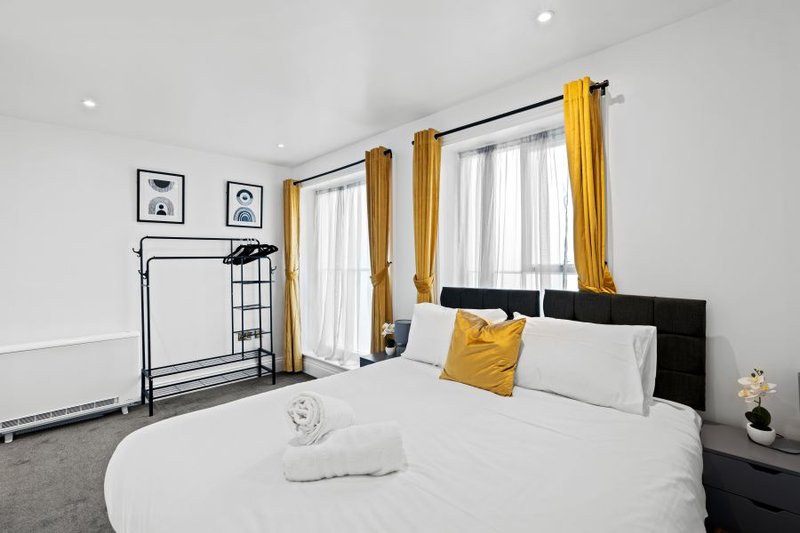 Bright bedroom with flexible king or twin bed configuration, fresh linen and storage for longer stays.