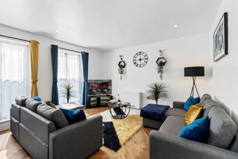 Comfortable living area with sofas and plenty of space for teams to relax after work.
