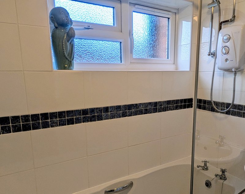 The bathroom features an overhead shower over the bath, providing a practical option for freshening up after a busy day on site. Complimentary toiletries are also provided.