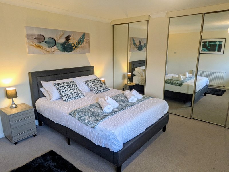 Spacious and comfortable bedroom with fresh linen and towels provided. The large mirrored wardrobes provide plenty of storage, making it an ideal space for short and long term guests.