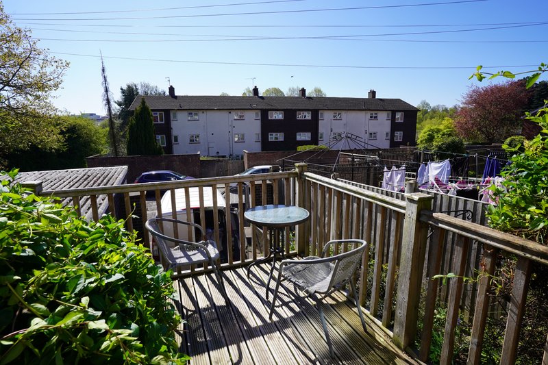 Private outdoor decking area overlooking the peaceful residential surroundings. Providing a lovely space to sit, relax and enjoy some fresh air, with a table and chairs ideal for morning coffee