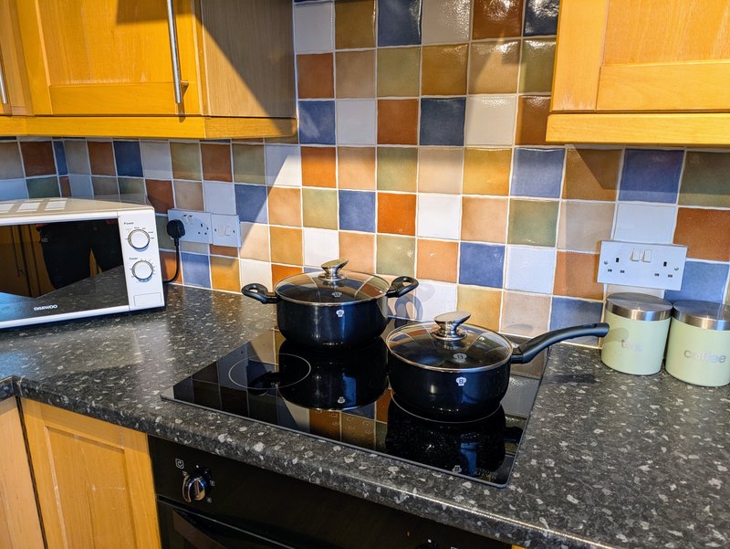 The spacious, well-equipped kitchen provides everything needed to prepare meals during your stay, making it a practical choice for working groups.