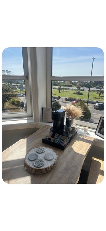 Modern kitchen window with countryside views, decorative items on wooden counter