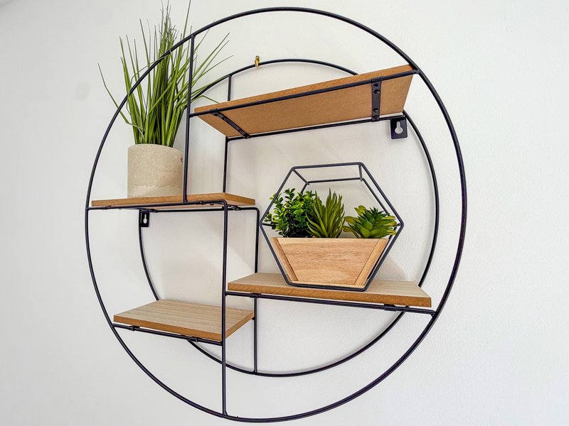 Wall-mounted circular shelving unit with wooden shelves and potted plants