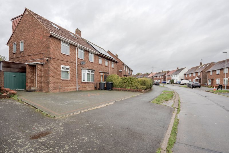 Brick semi-detached house with driveway, front garden and residential street view