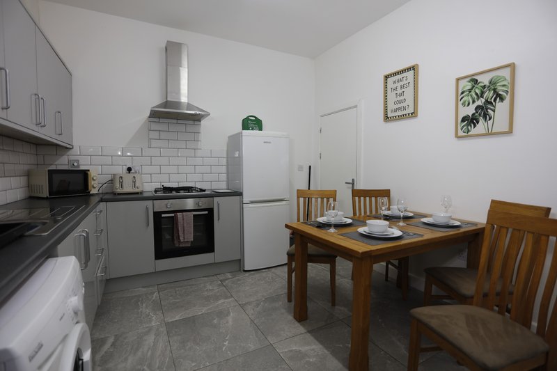 Spacious kitchen and dining area with a solid wooden dining table seating 6.