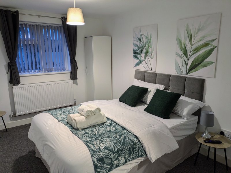 A comfortable, practical bedroom with a quality bed, fresh linen and towels, bedside table and lamp, plus storage for work clothes and belongings. A great space to relax and recharge after a busy day