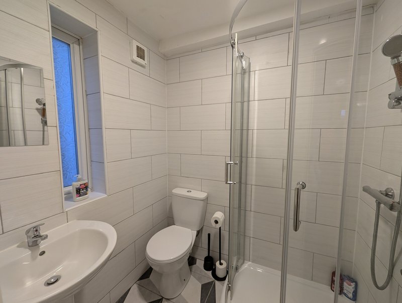 One of four private ensuites, each offering a walk-in shower, toilet and wash basin, with complimentary toiletries provided for guests.