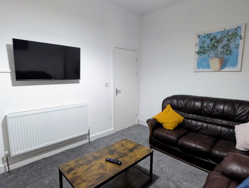 A comfortable lounge with plenty of seating, a large Smart TV and a spacious coffee table—perfect for relaxing after a busy day.