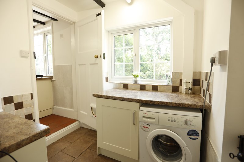 Practical additional kitchen space with generous worktop area and a washing machine, making it particularly useful for contractor groups staying for longer periods.