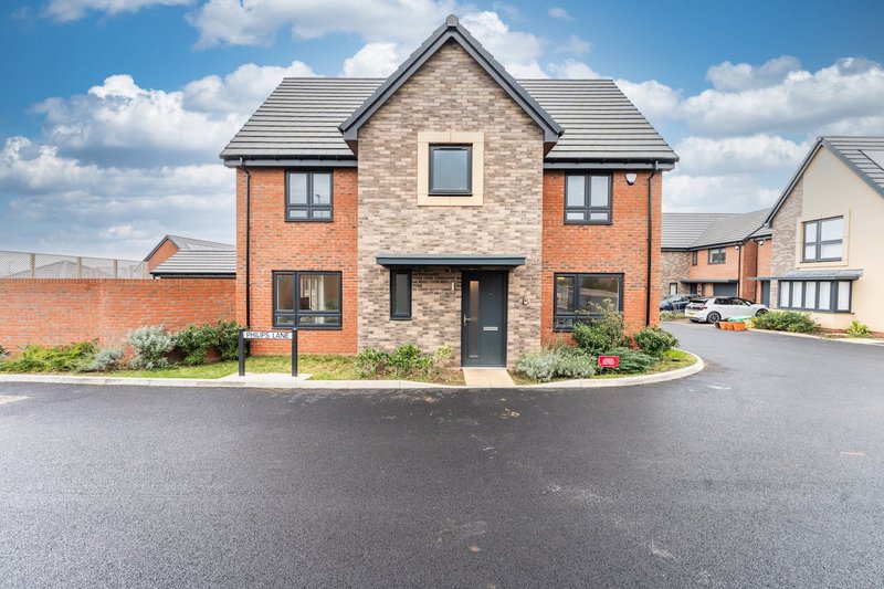 Modern brick detached house with driveway, front garden and neighboring properties visible